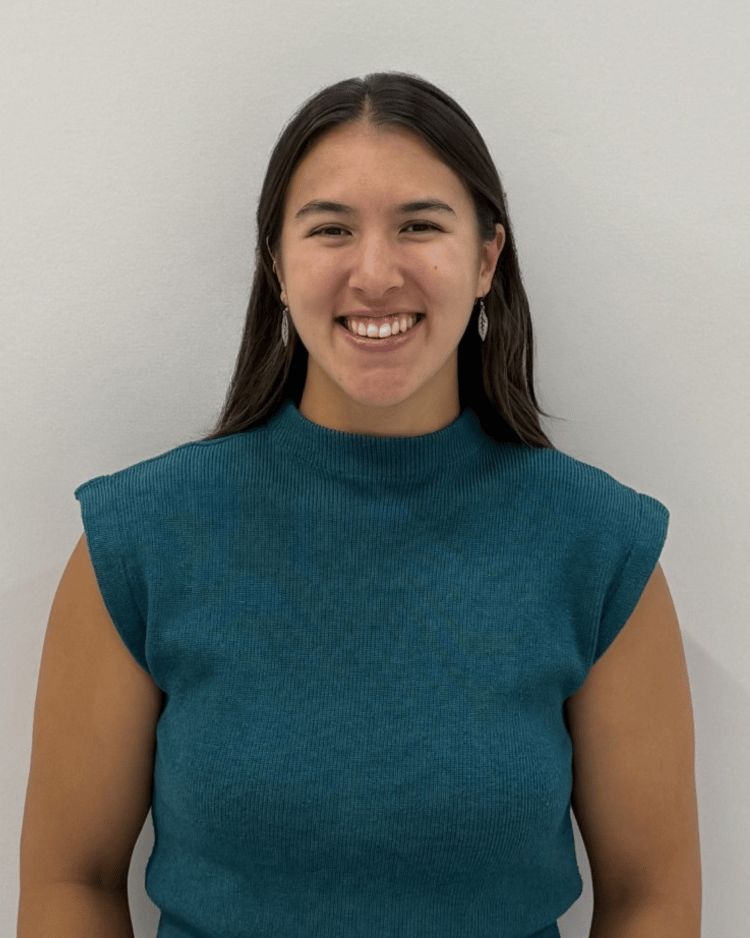 Smiling woman with long brown hair and green top
